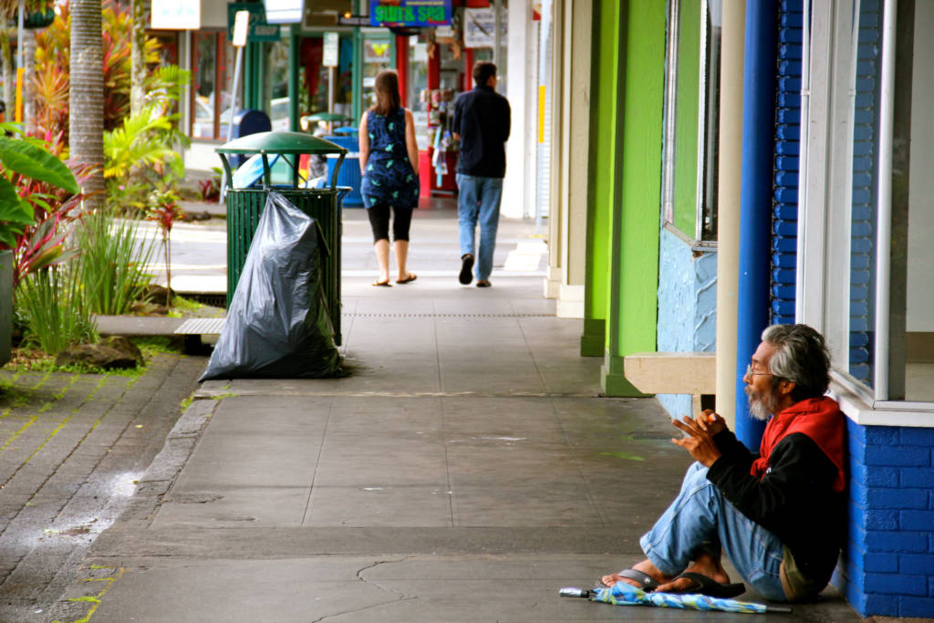 Photo of homeless man on the sidewalk