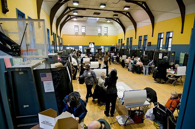 a photo of people who are voting at the hall