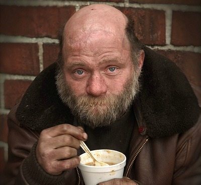 a photo of a man who looks hungry staring at camera