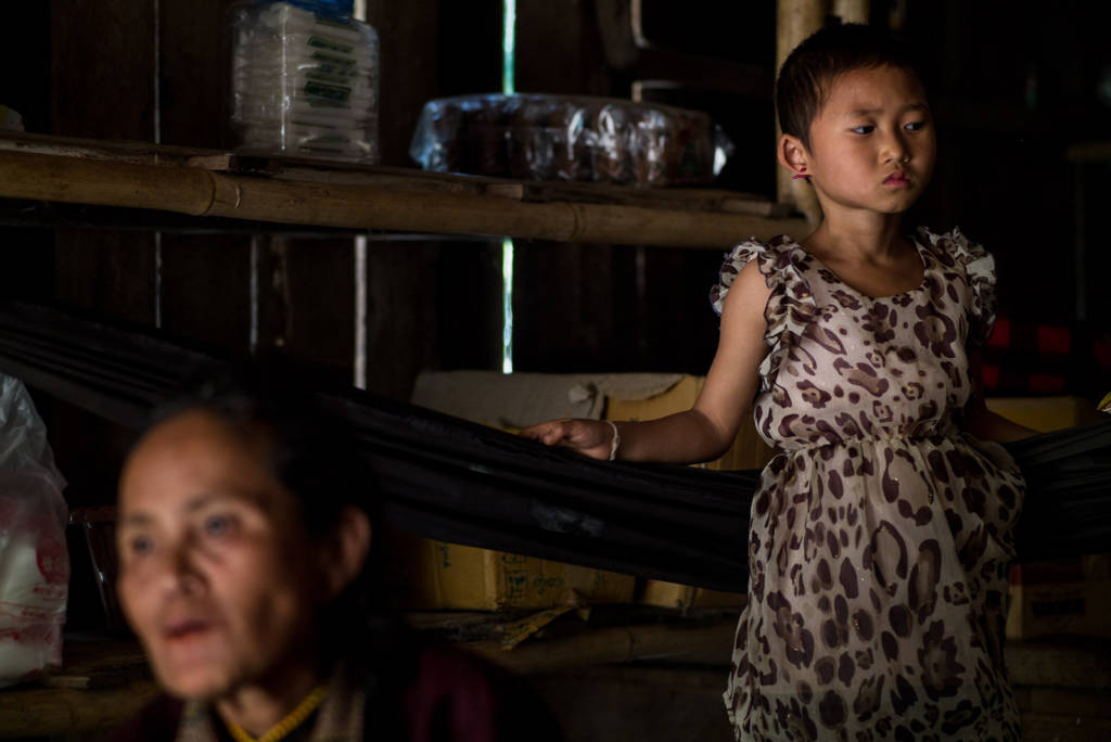 Karen girl and her grandmother in their family's shop