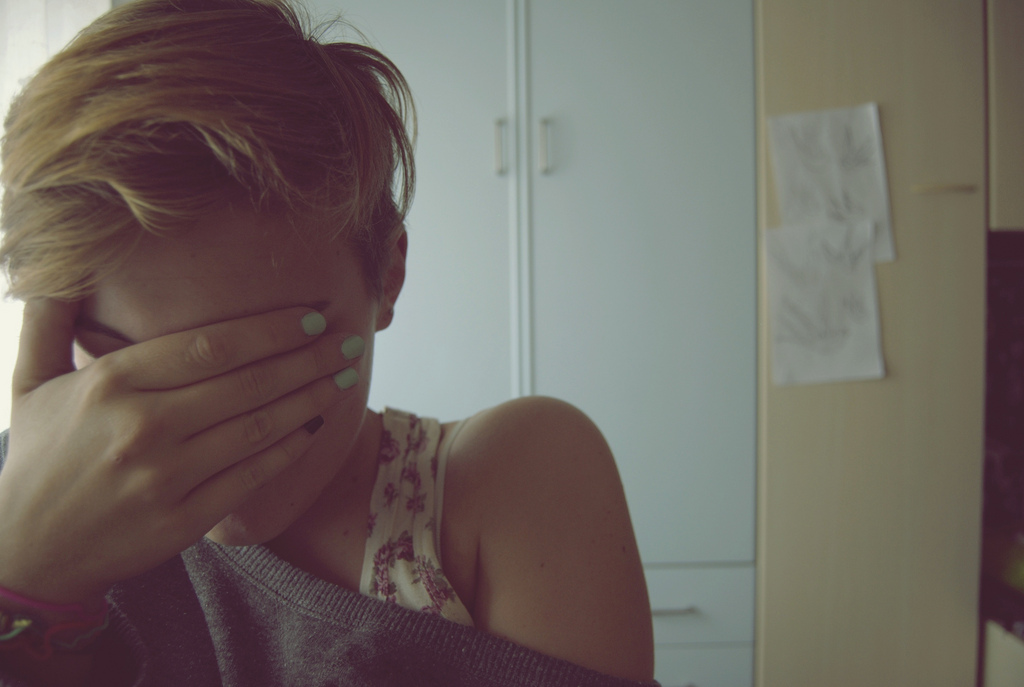 A woman holding her face