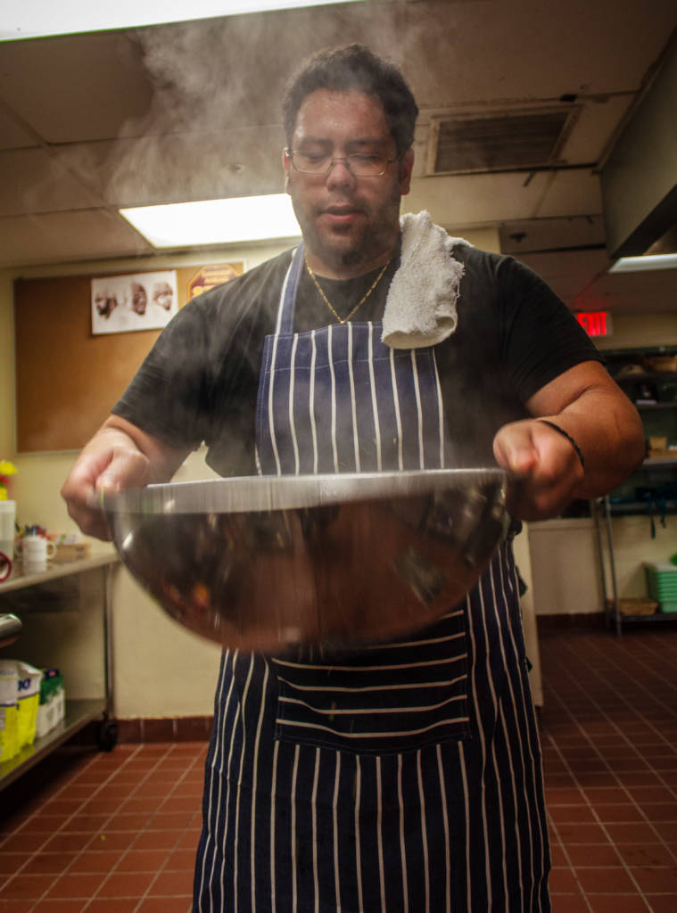 Man holding bowl of soup