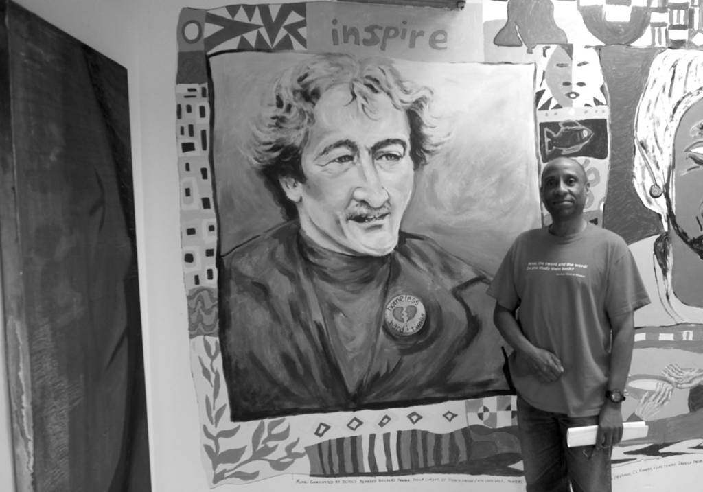 photo of donald page in front of a CCNV Mitch Snyder mural