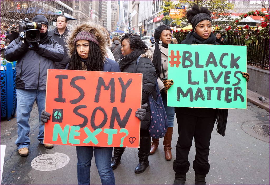 Photo of two women participating in a Black Lives Matter protest.