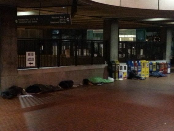 Photo of people experiencing homelessness sleeping in the cold at the Rosslyn Metro Station in 2013.