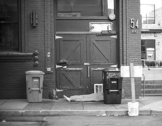 Image of homeless person sleeping on the street.