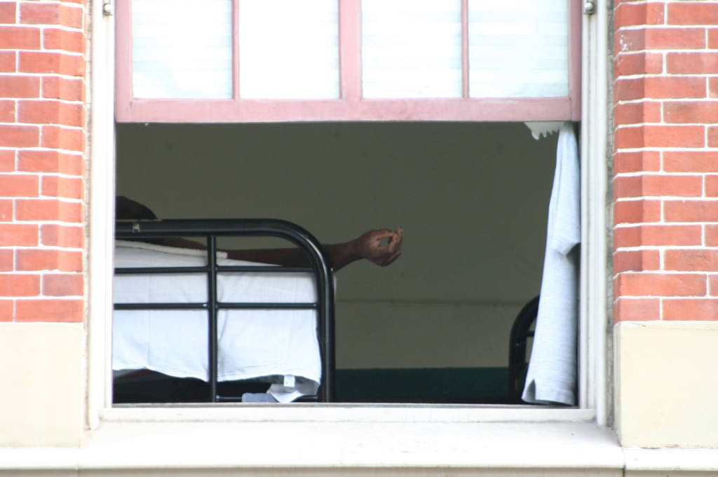 An image taken looking to an open window of a homeless shelter