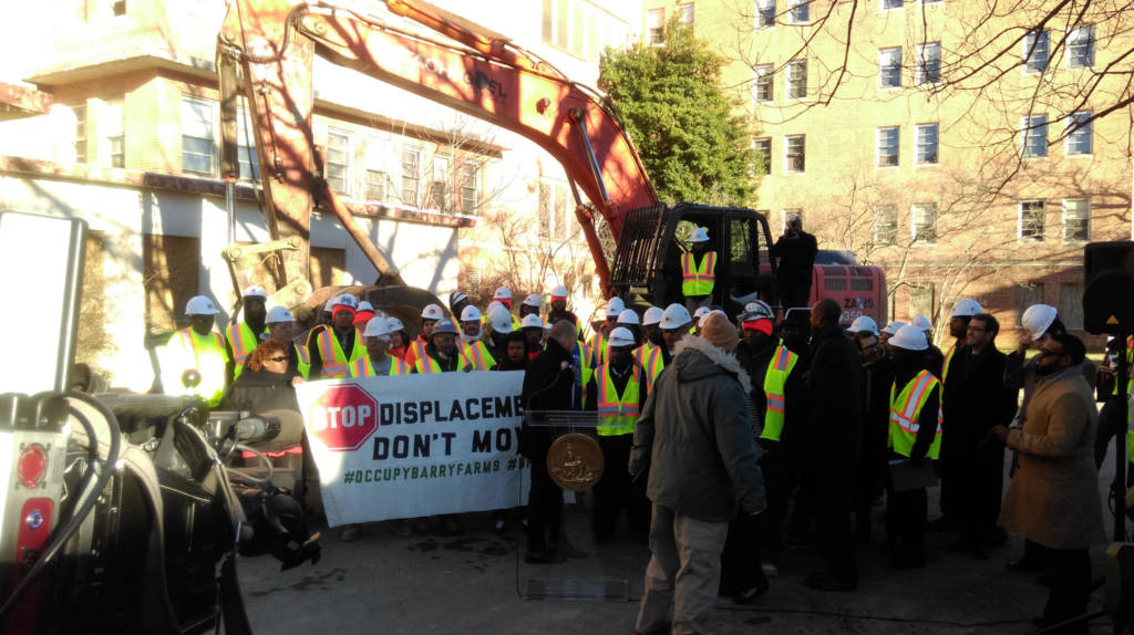 Construction workers, Ward 8 residents and city officials participate in a ceremonial demolition to kick off Phase One development of St. Elizabeth's East.