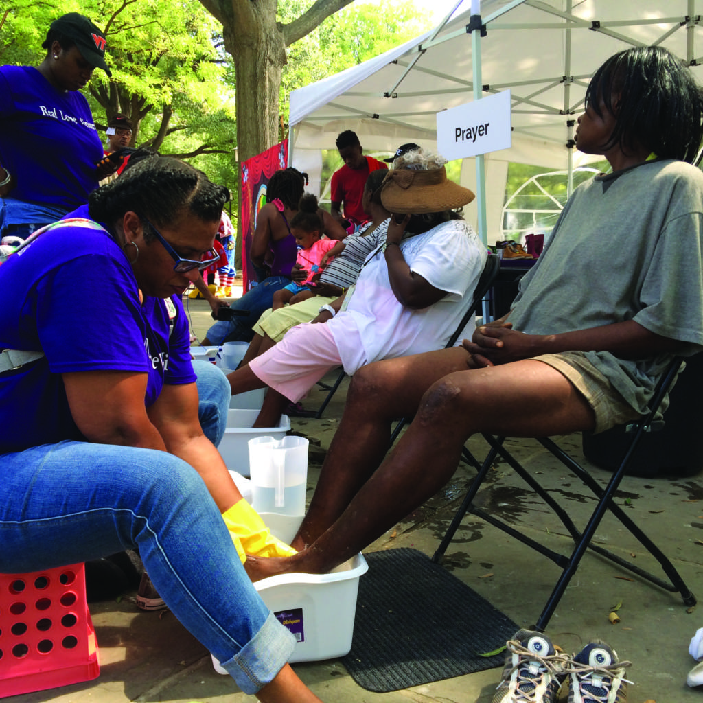 Sonia Edmonds has her feet washed by Gail Anderson.