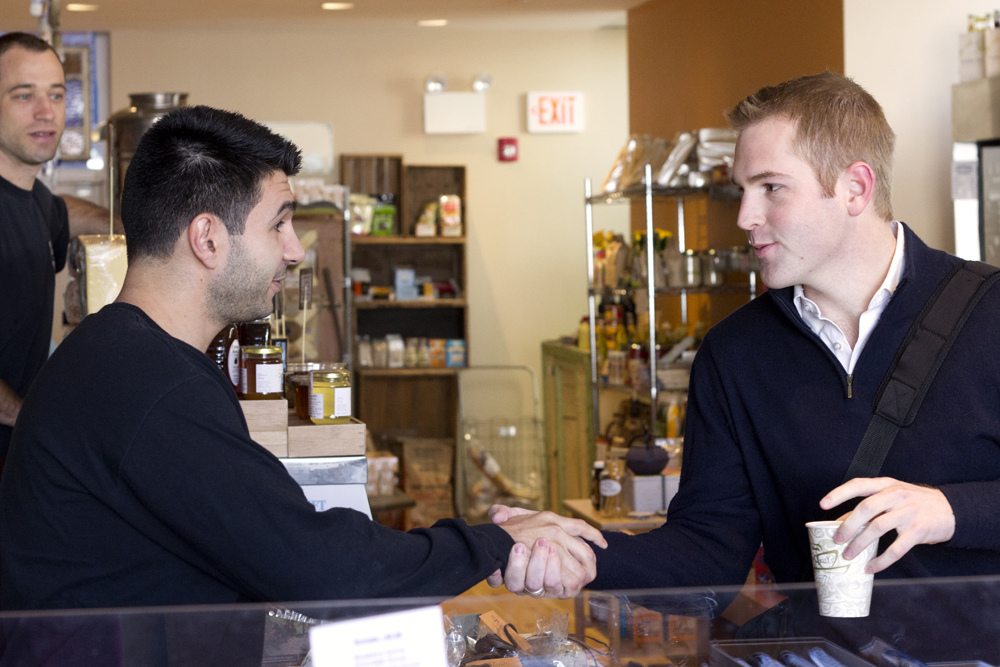 A picture of an employee shaking a customer's hand.