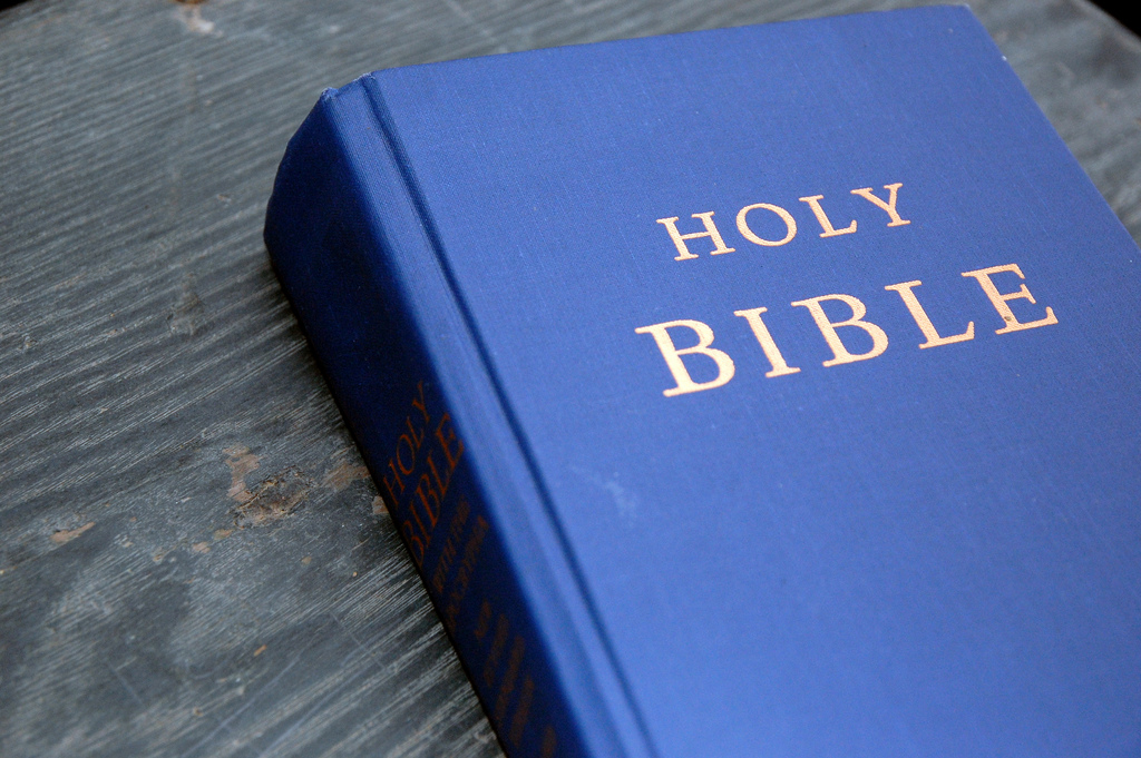 A Bible sitting on a desk.