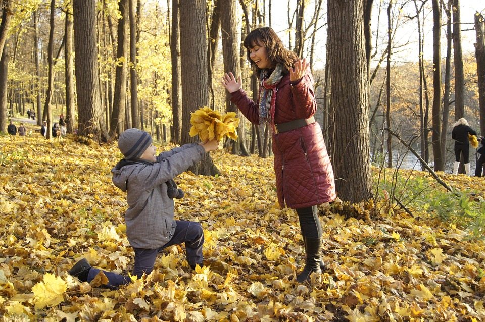 A photo of a boy giving his mother flowers