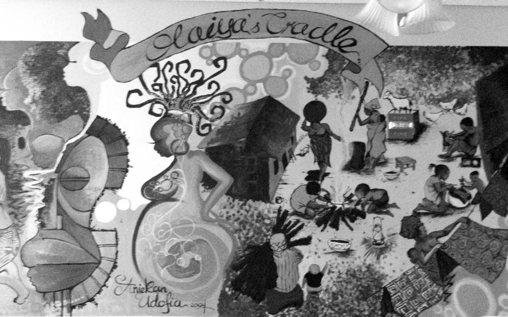 This is a photo of a mural in the hall of Olaiya’s Cradle depicts stylized scenes of young motherhood