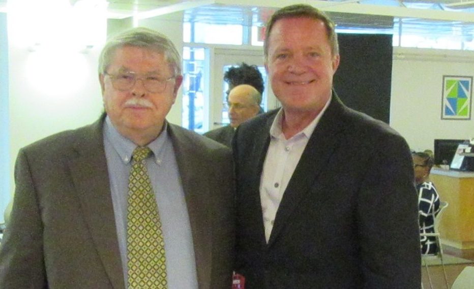 Dennis Culhane stands next to a colleague at an Open Arms Housing fundraiser at Pepco Gallery