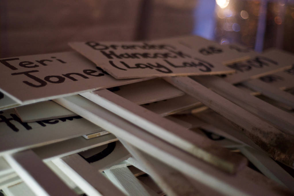 Close-cropped photo so a stack of white signs with black text on them