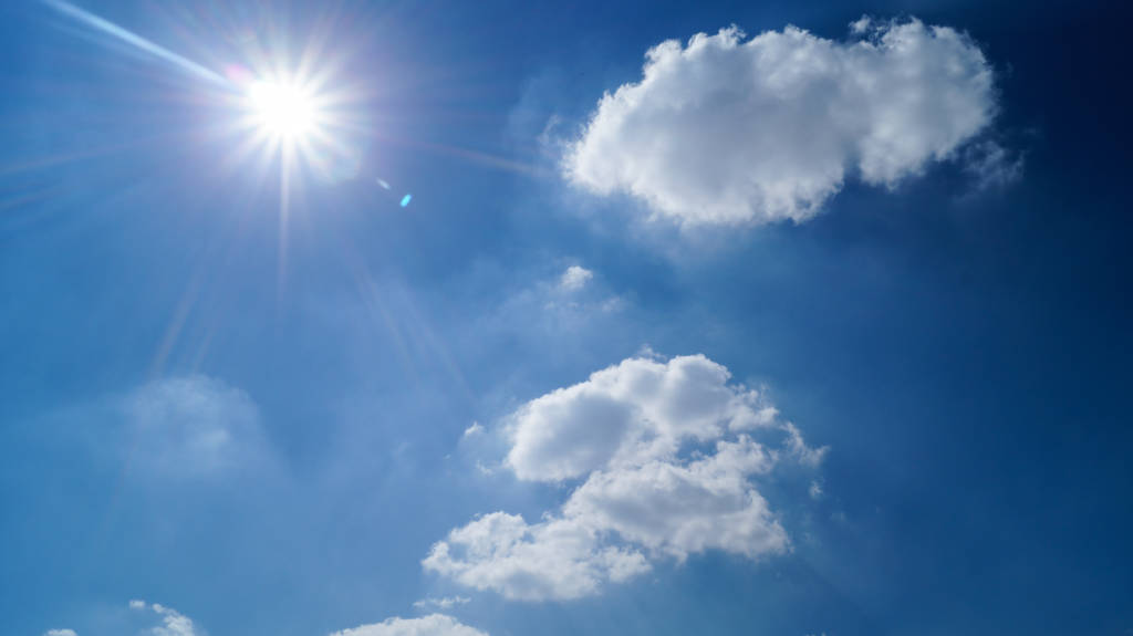 A picture of the sun and some clouds