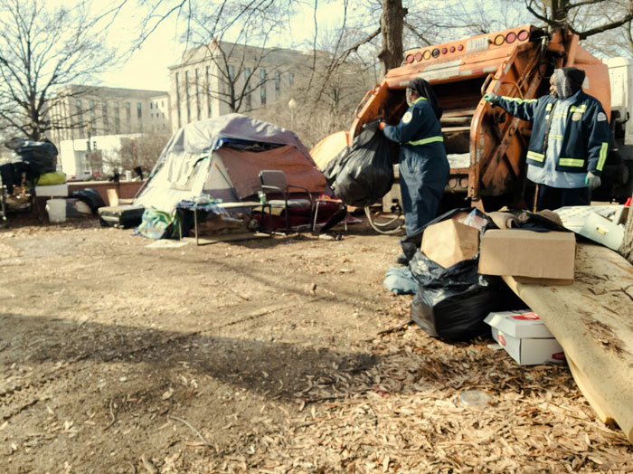 Photo of public works employees cleaning up an encampment on E and 21st streets Northwest