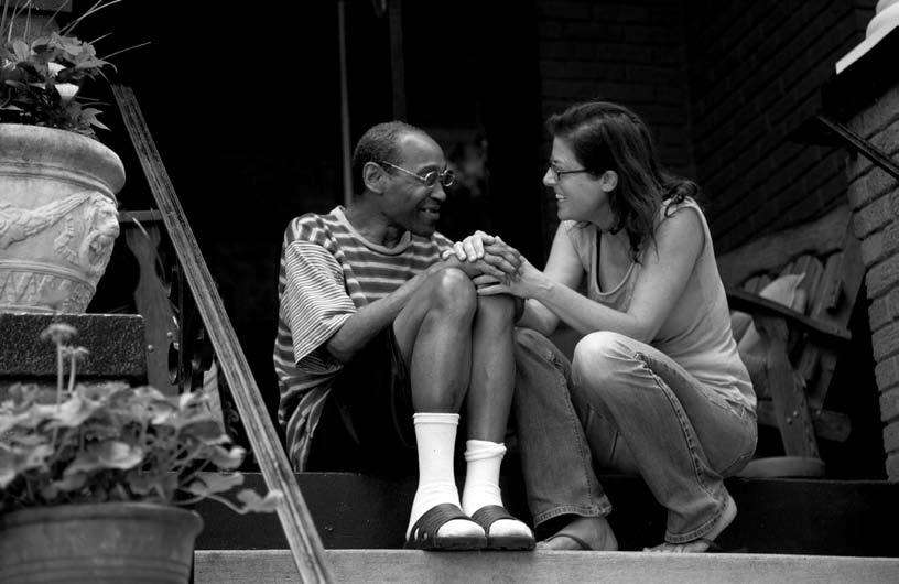 A patient at Joseph’s House talks with a nurse on the steps outside. Patients with end-stage HIV/AIDs, end-stage cancer, and other terminal illnesses receive treatent at the hospice.