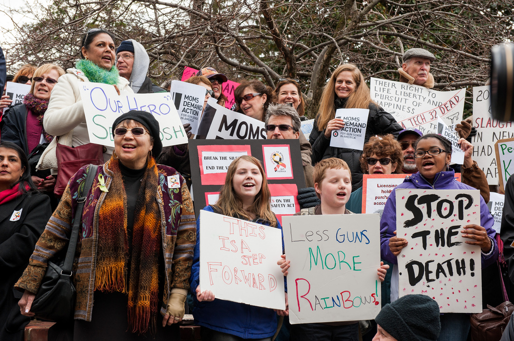 Marchers hold up their signs protesting gun violence