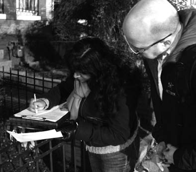 Group leader Lissa Ramsepaul and Gavin, a volunteer, review their survey results.