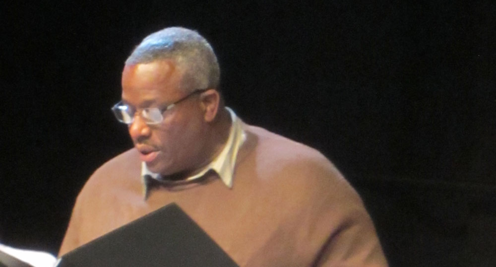 A photograph of Leonard Hyater performing during a staged reading.