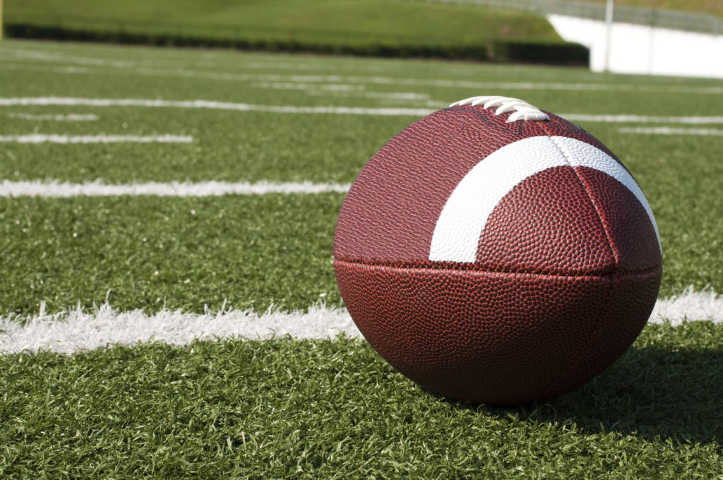 A football on a field.