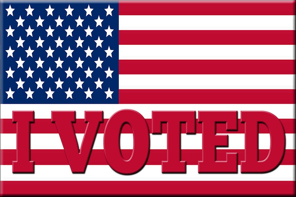 A photograph of an american flag with the words "I Voted".