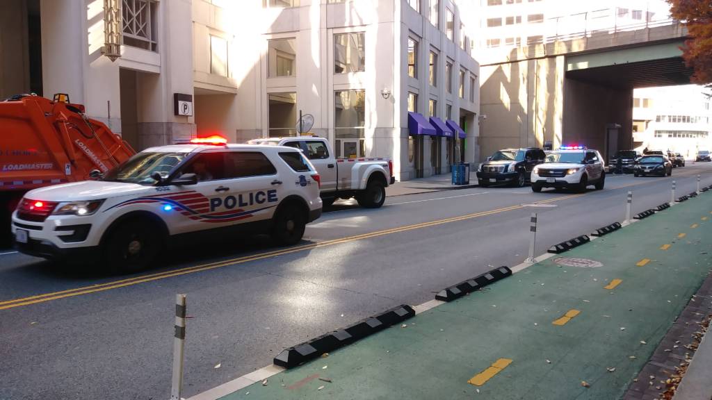 Photo showing several MPD vehicles with their lights flashing.