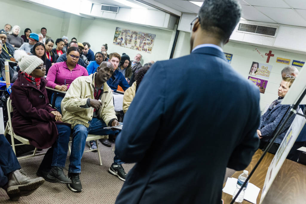 Photo of Ward 5 Councilmember Kenyan McDuffie speaking to a packed room.