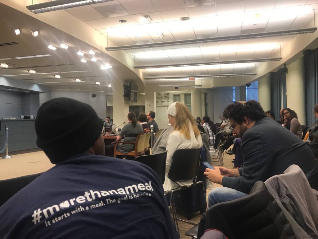 Photo of the crowd and witness table in the DC Council hearing room.