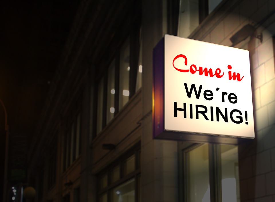 Photo of a hiring sign attached to a building