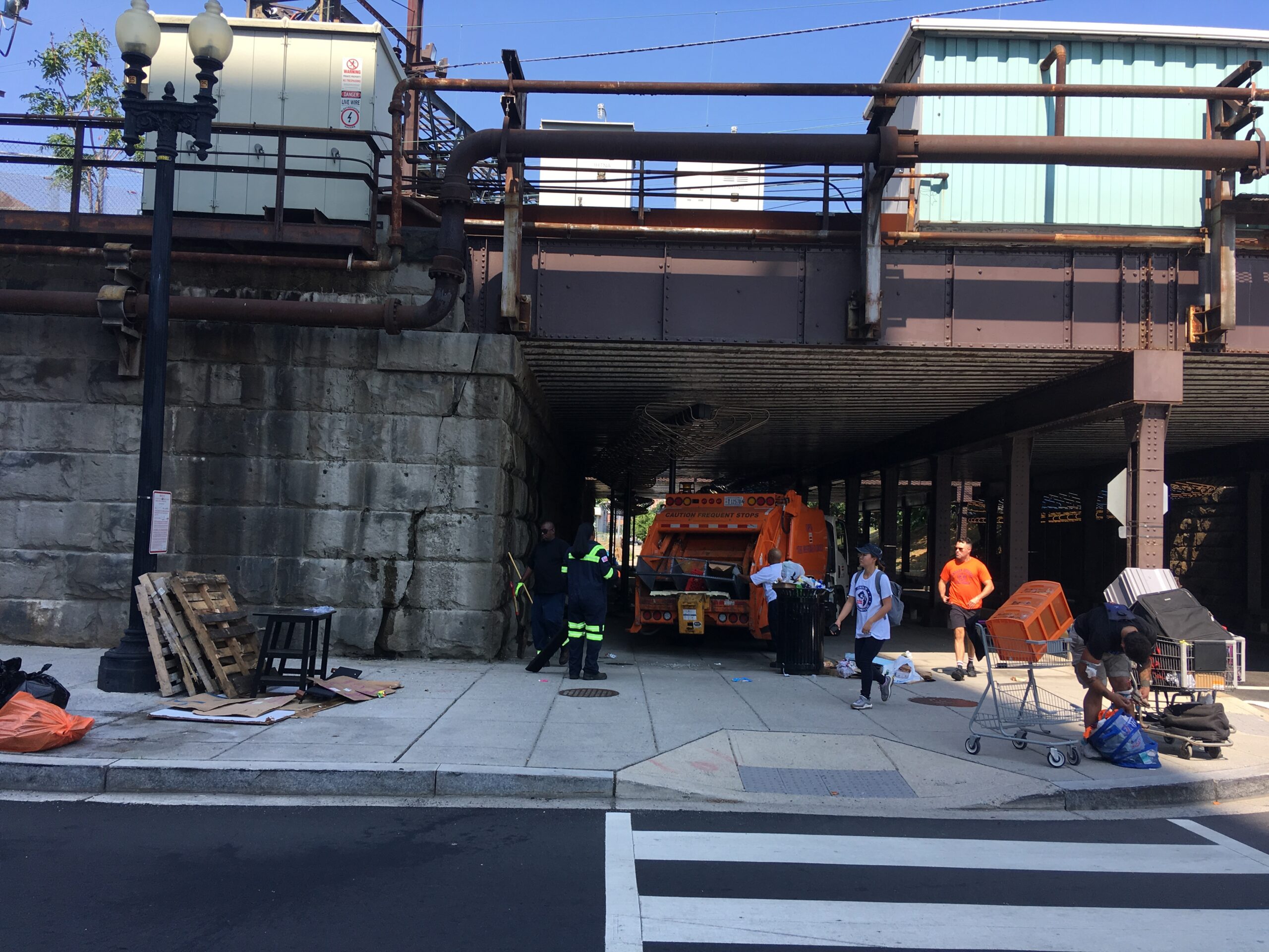 A photo of city workers and homeless residents at an encampment cleanup in D.C.