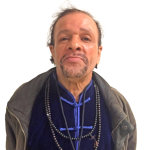 Portrait photo of Ayub Abdul from the shoulders up.