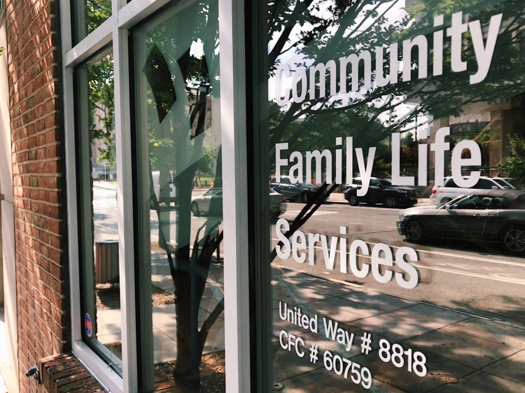 Photo of a window with white lettering on it.