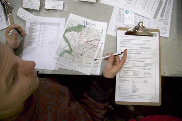 Photo of a many with maps and a pencil
