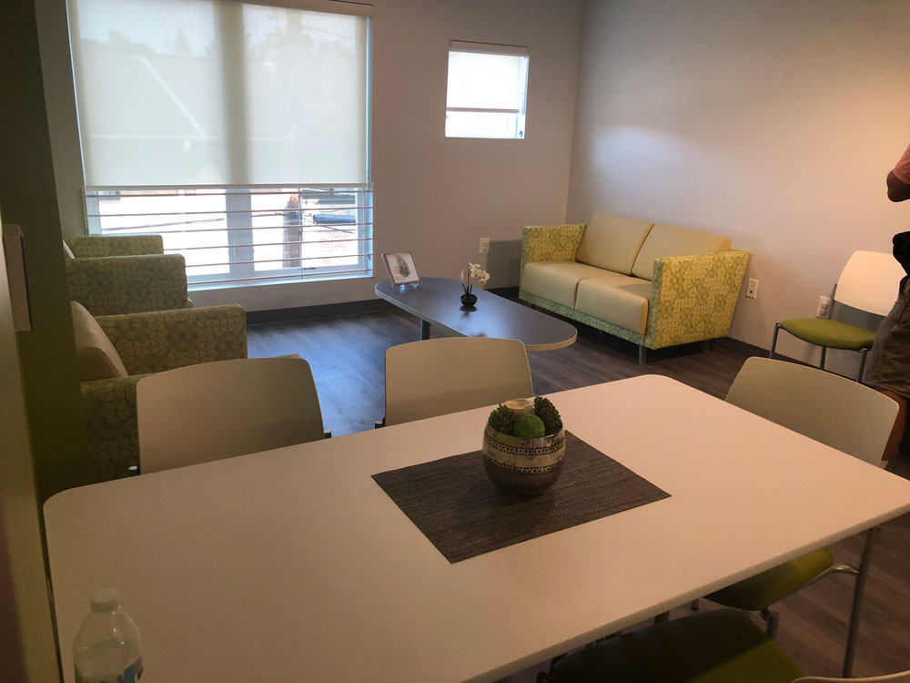 A photo displaying multiple couches and pieces of furniture in a shared room.