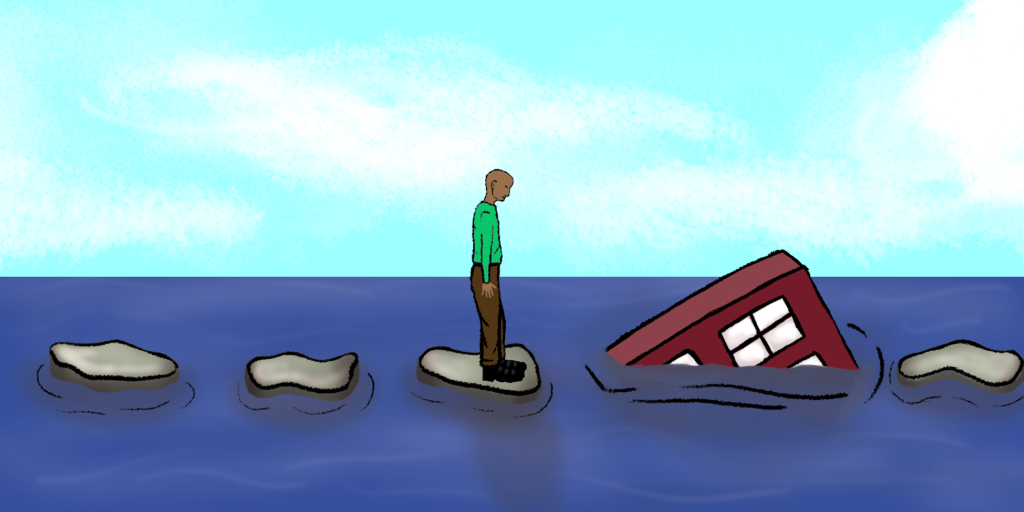 Man standing on rock in water looking at Hope Village sinking into the water.
