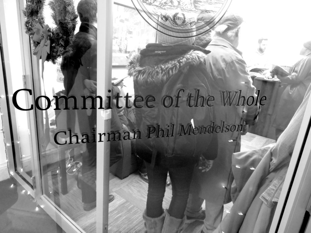 The door leading into the office of D.C. Council Chairman Phil Mendelson; in the background are some people.