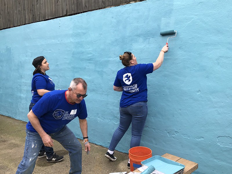 Photo of women painting a wall at Calvary Women's Services