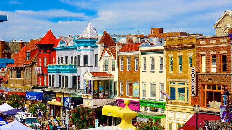 A photo of colorful buildings in front of a blue sky.