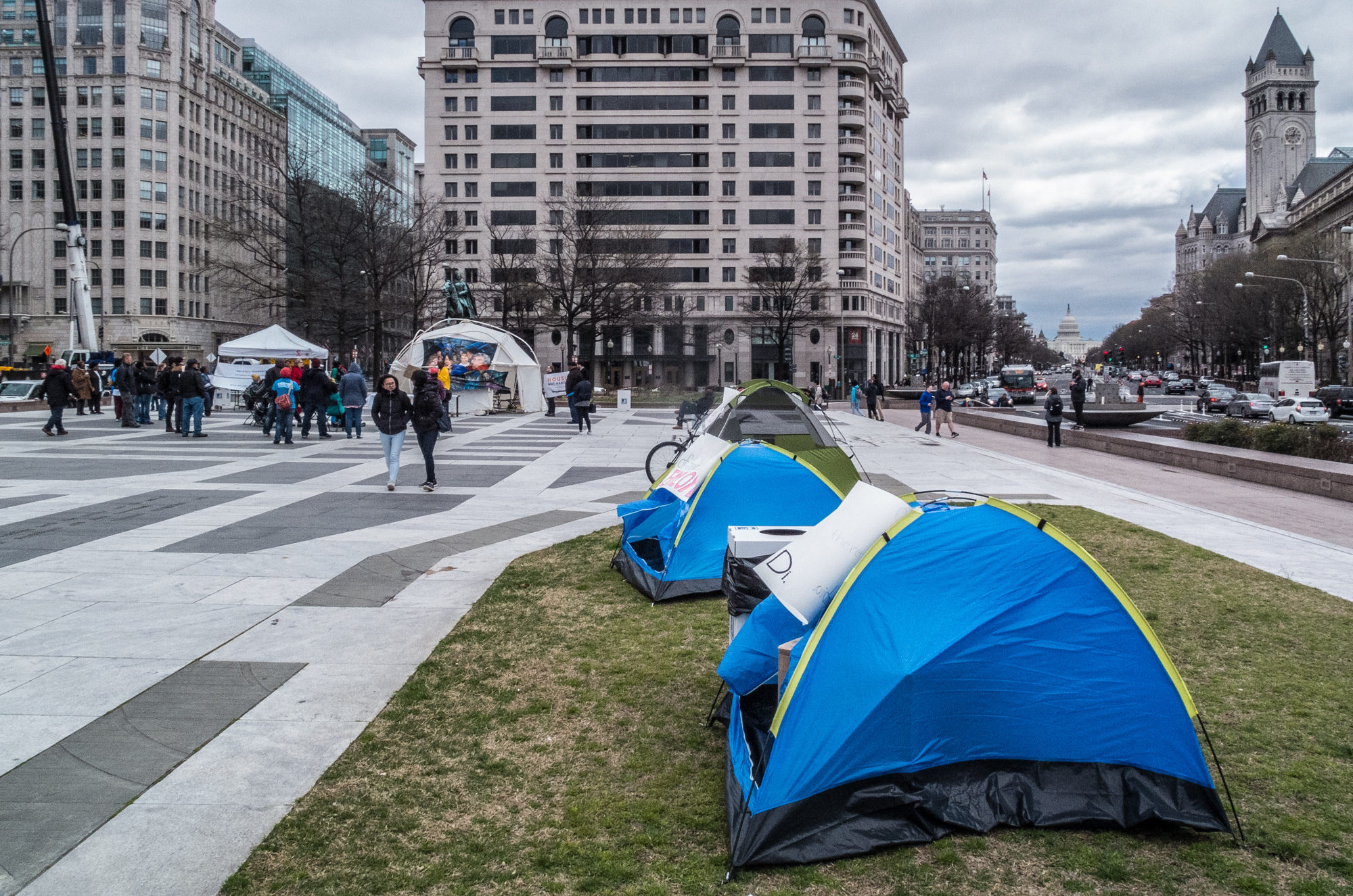 An image of tents in front of a large plaza.