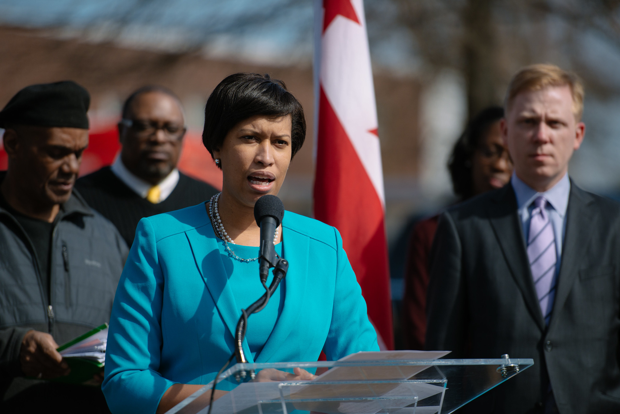 A Black woman speaking at a podium