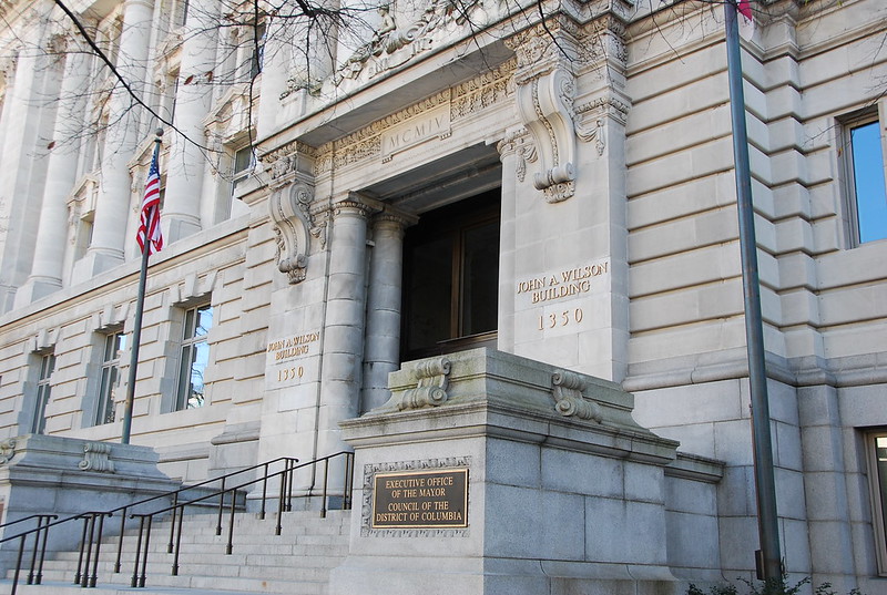 A white stone building, labeled the John Wilson building.