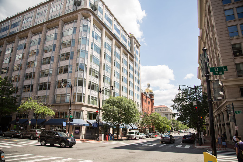 A white building sits at an intersection in downtown D.C.
