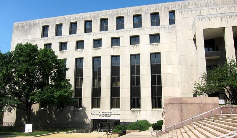 A grey stone building sits against a blue sky.