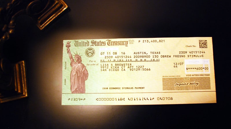 A government stimulus check on a dark background.