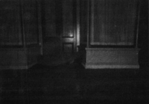 A photo of a dark corner of a building. 