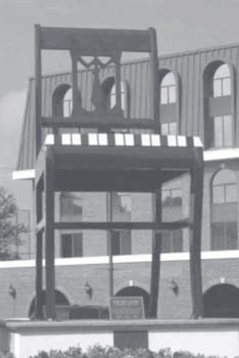 An image of "The Big Chair" sculpture located in Washington, DC. It is a chair that stands nearly 20 feet tall.