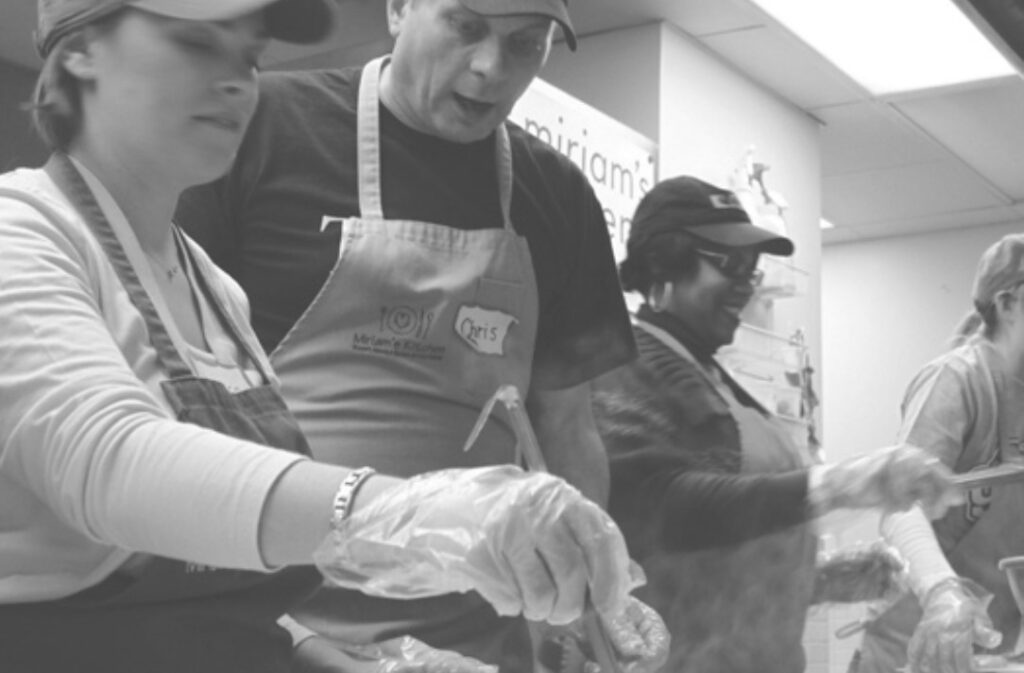 An image of volunteers preparing meals in Miriam's Kitchen.