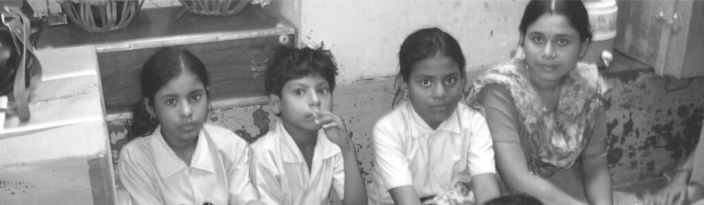 A photo of children setting at a support center.